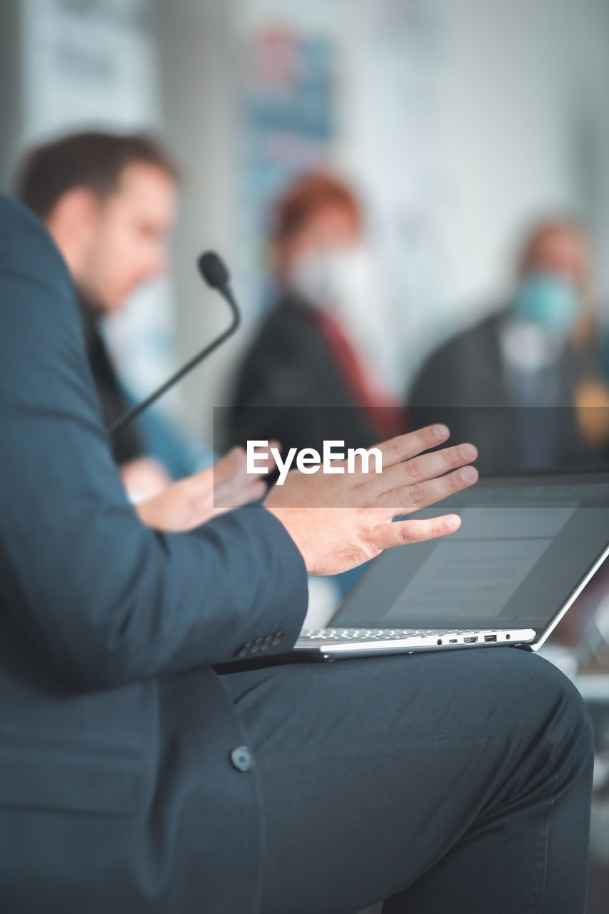 Man with laptop having a presentation at seminar gathering