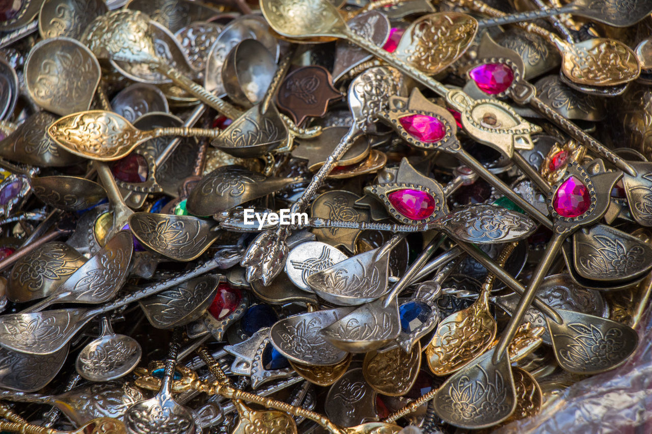 FULL FRAME SHOT OF COINS ON PATTERNED FLOOR