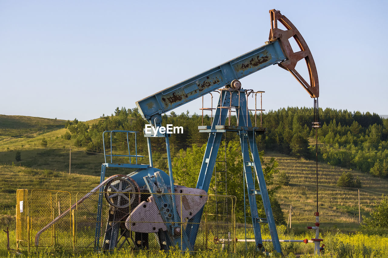 Working oil pump from oil field. industrial equipment. bashkortostan, russia - 12 june, 2021.