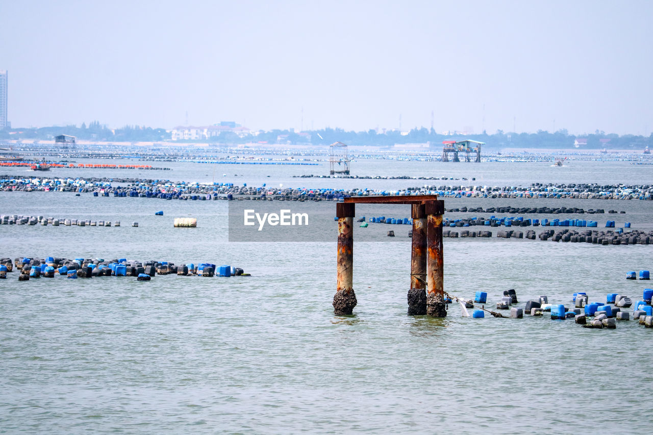 Boats in sea against clear sky