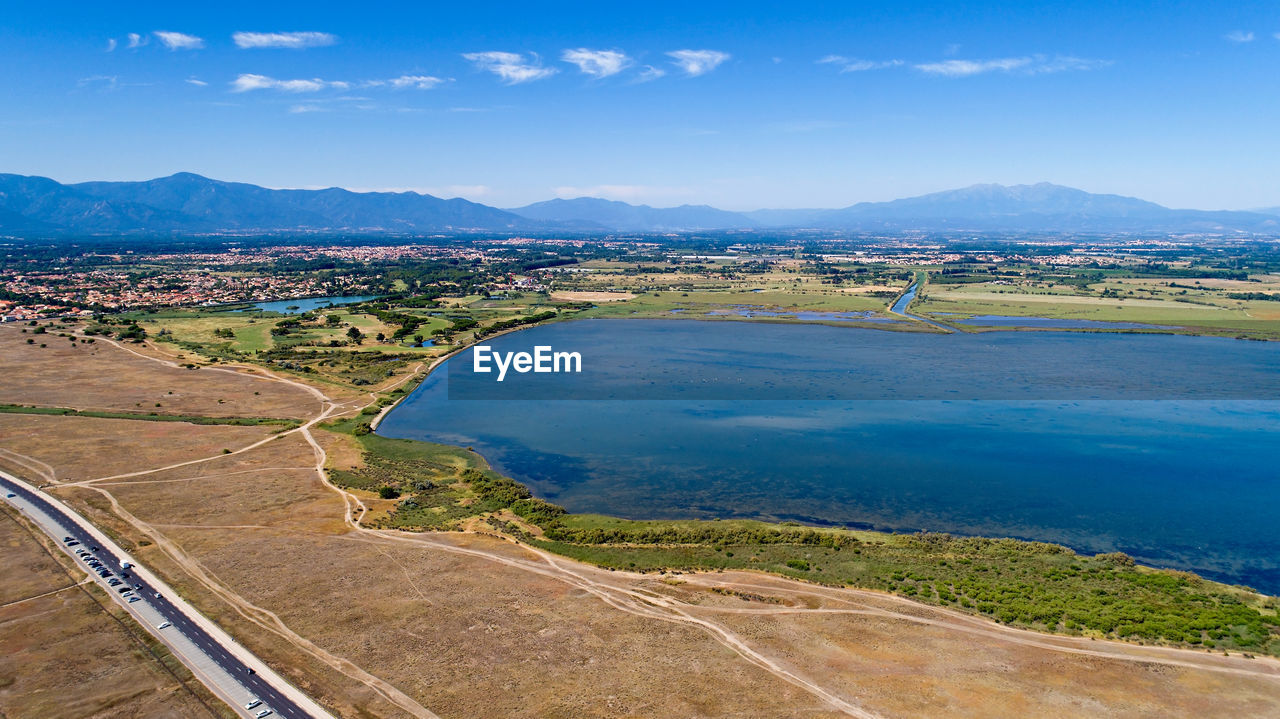 Scenic view of landscape and lake against sky