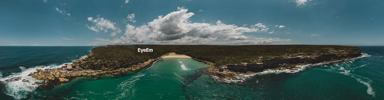 HIGH ANGLE VIEW OF SEA WAVES AGAINST SKY