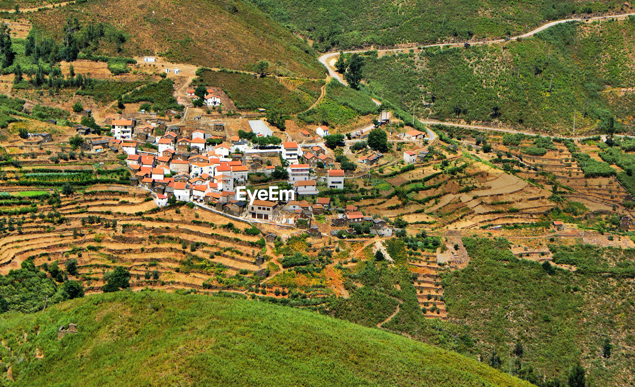 HIGH ANGLE VIEW OF HOUSES IN VILLAGE DURING SUNSET