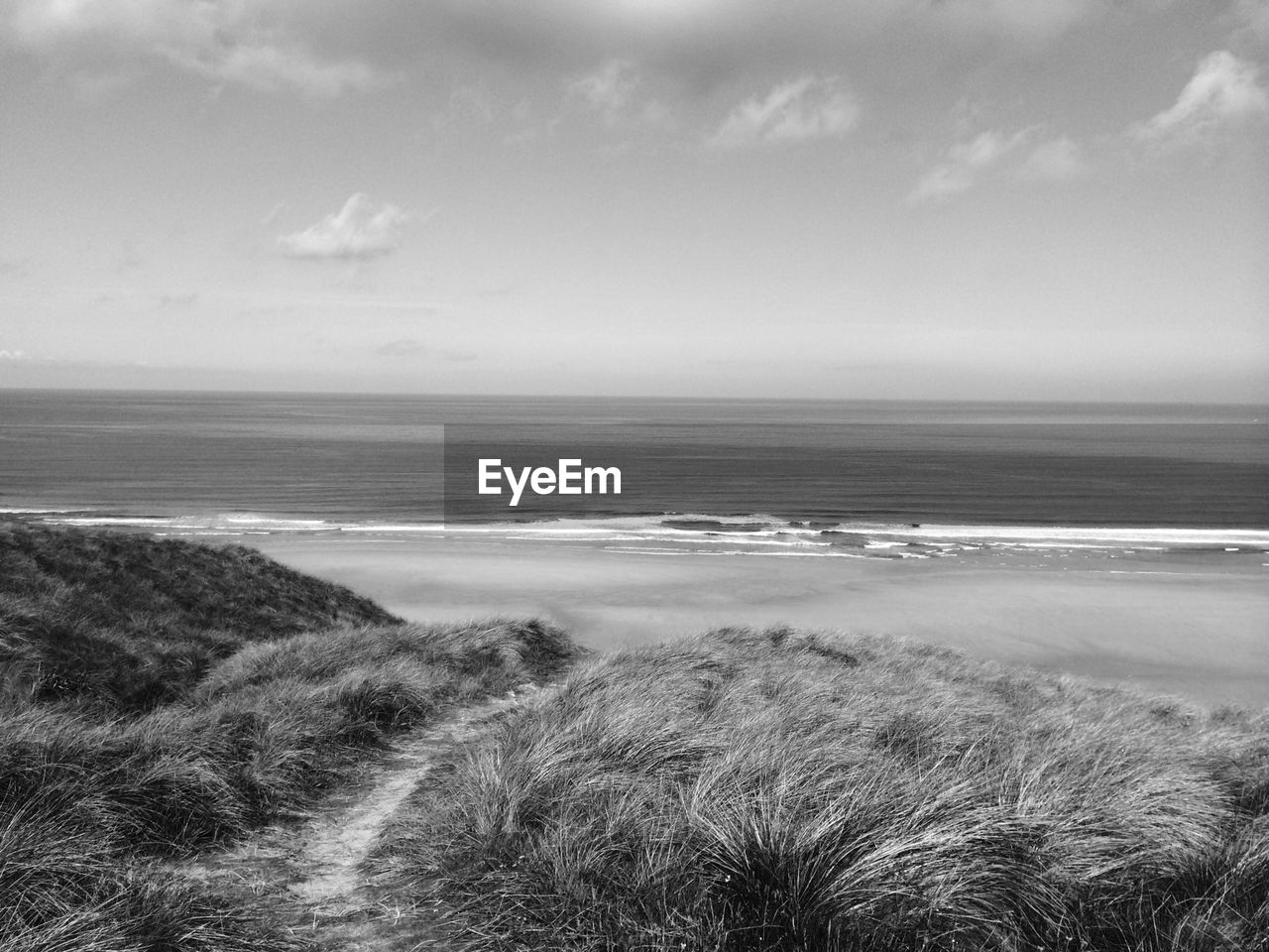 Scenic view of sea against sky on sunny day