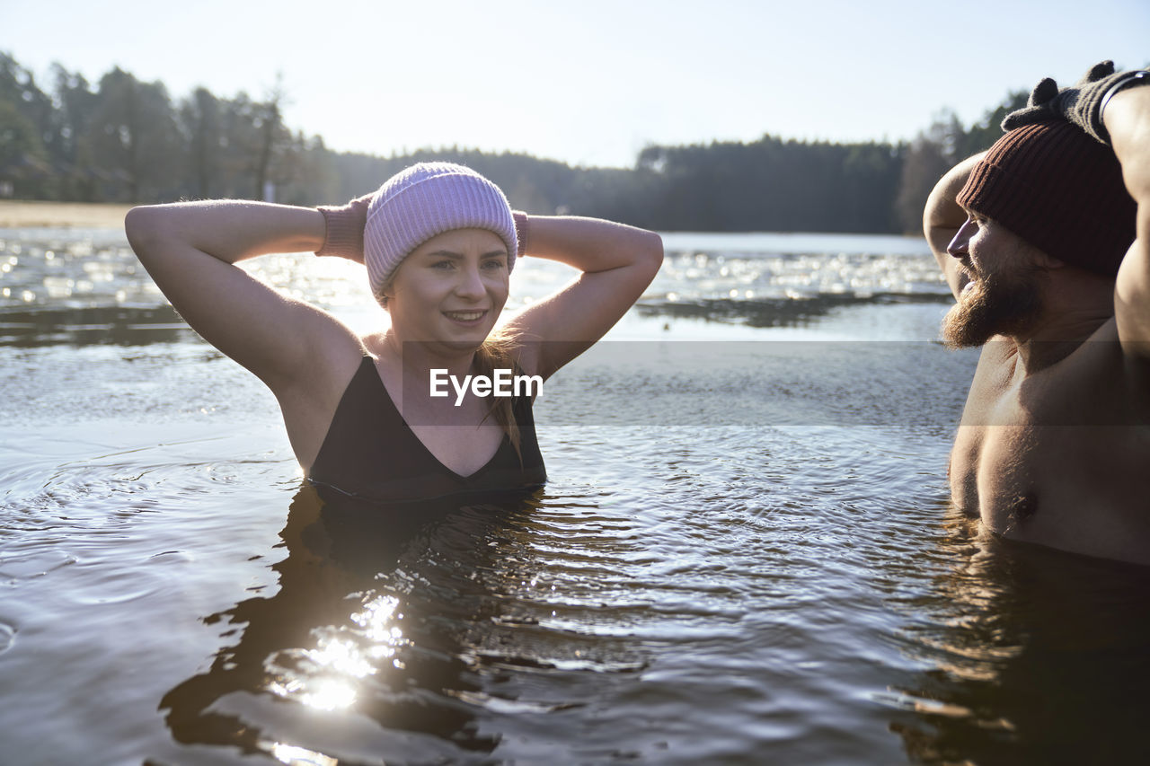 Young couple in lake during sunrise