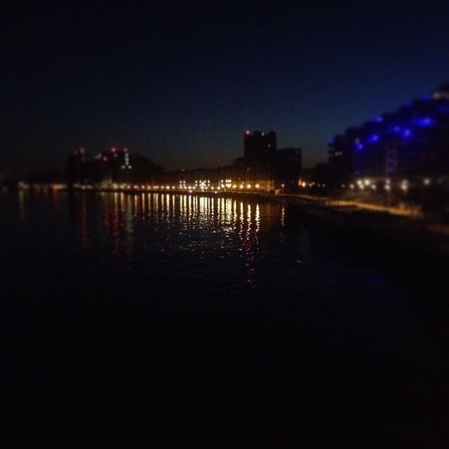 VIEW OF ILLUMINATED STREET LIGHTS IN CITY AT NIGHT