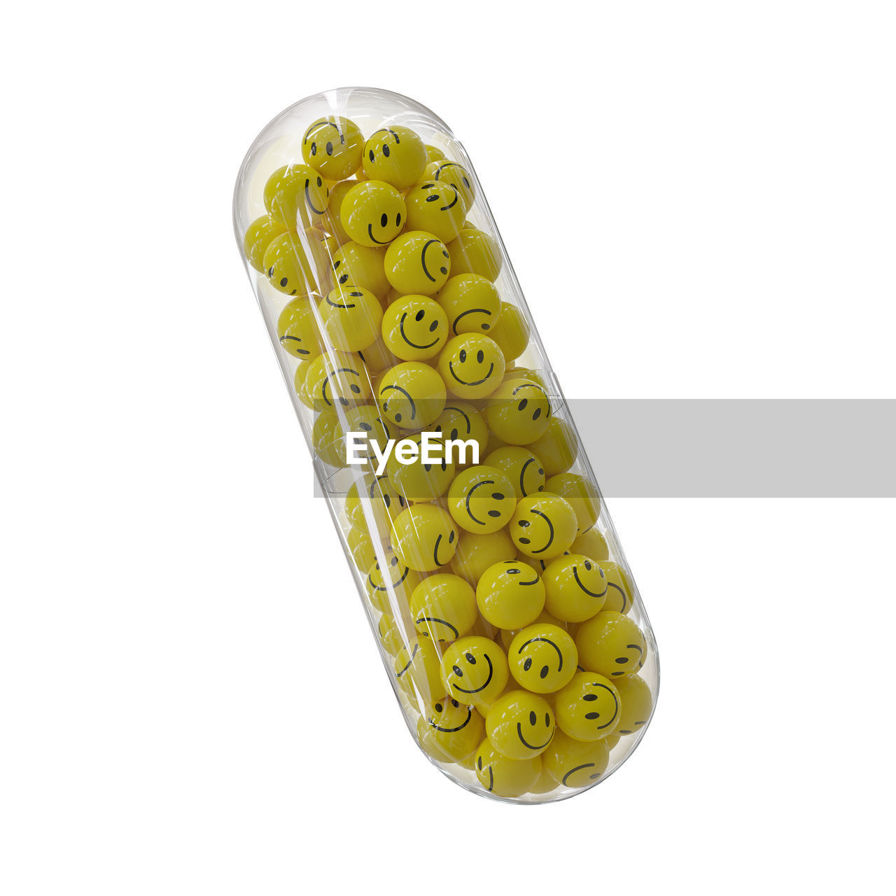 Smiley balls in transparent capsule against white background