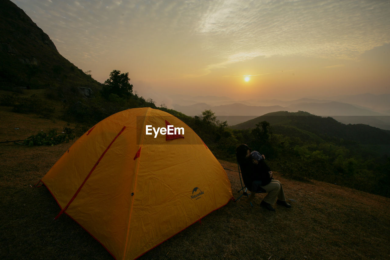 SCENIC VIEW OF MOUNTAIN AGAINST SKY DURING SUNSET