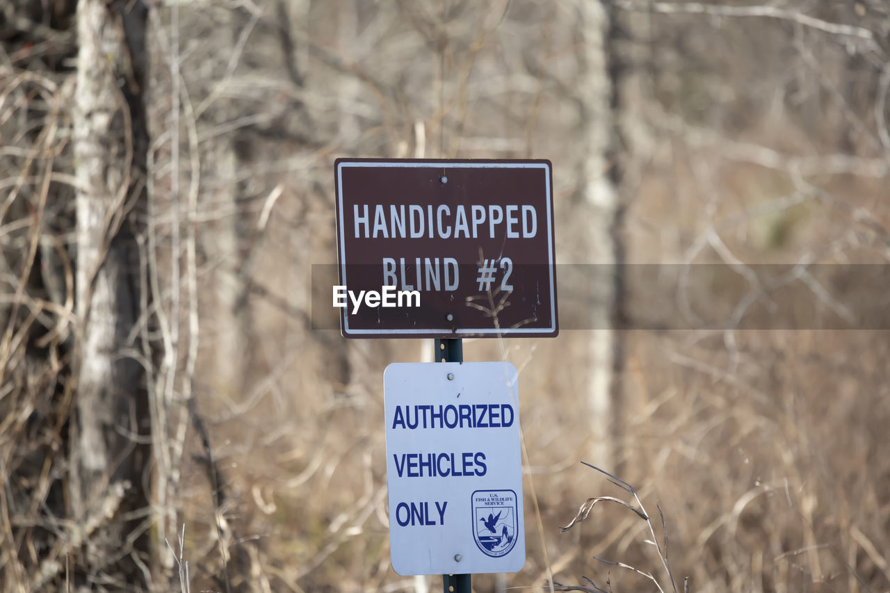 communication, sign, text, western script, plant, information sign, guidance, nature, no people, day, focus on foreground, land, warning sign, outdoors, tree, close-up, road sign, winter, symbol, trail, road