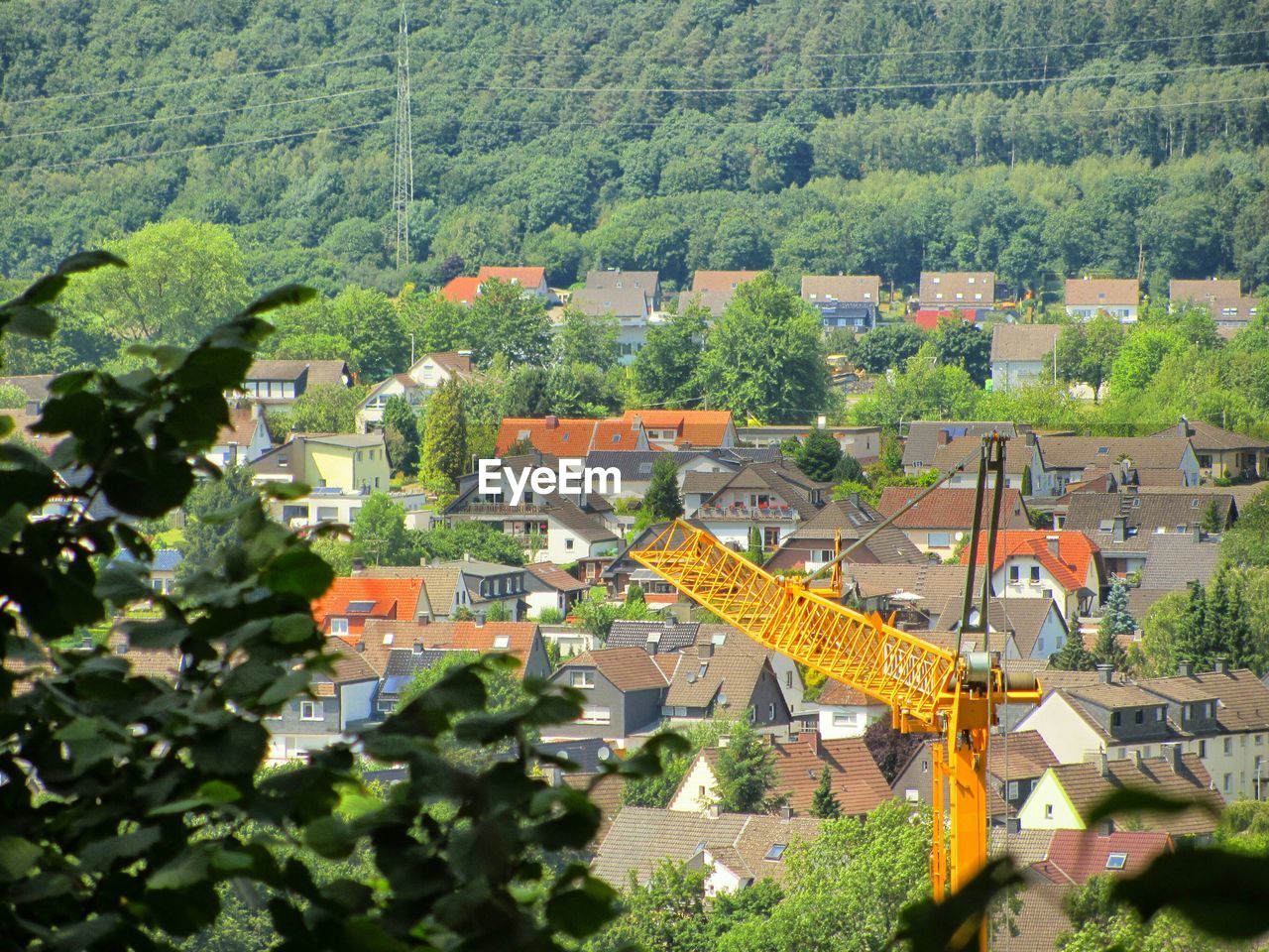 High angle view of crane in crowded town