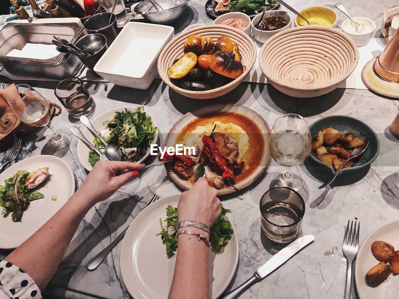 Cropped hands of woman having food at table
