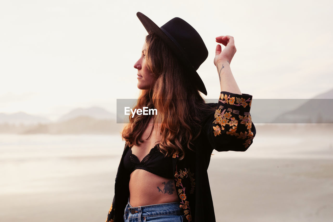 Beautiful, stylish woman on cox bay beach in tofino