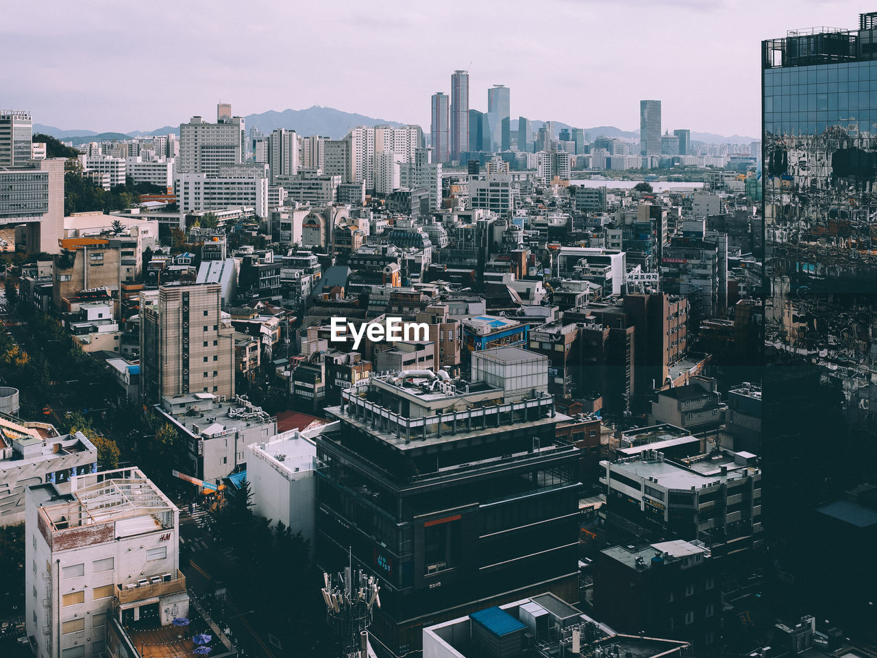 High angle view of modern buildings in city against sky