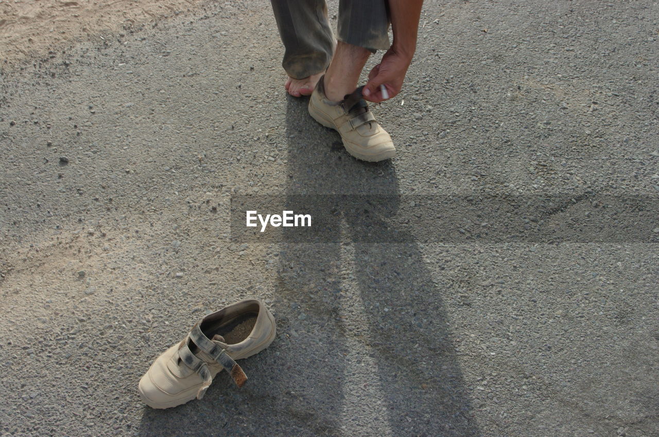 LOW SECTION OF WOMAN WEARING SHOES