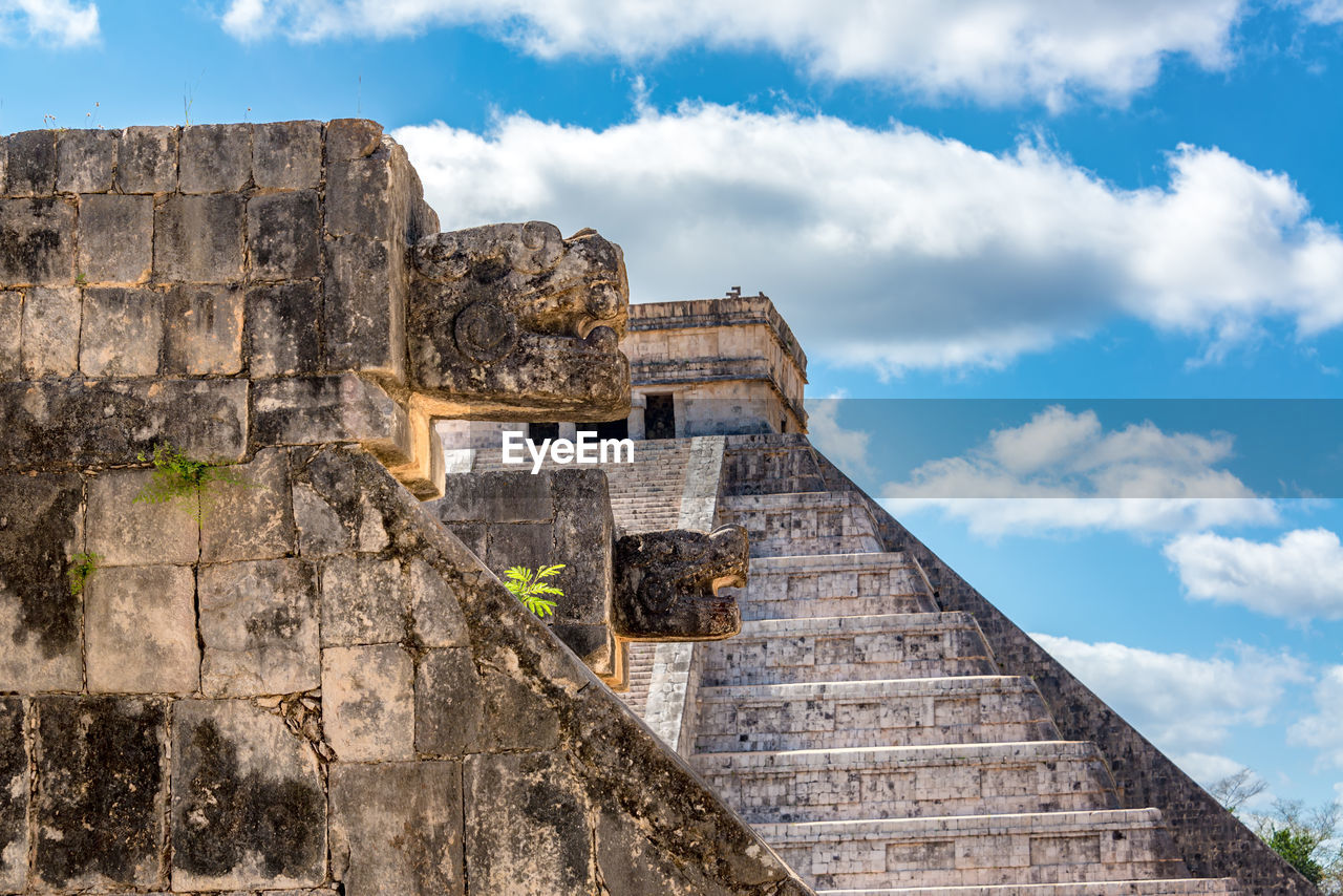 Close-up of sculptures against kukulkan pyramid