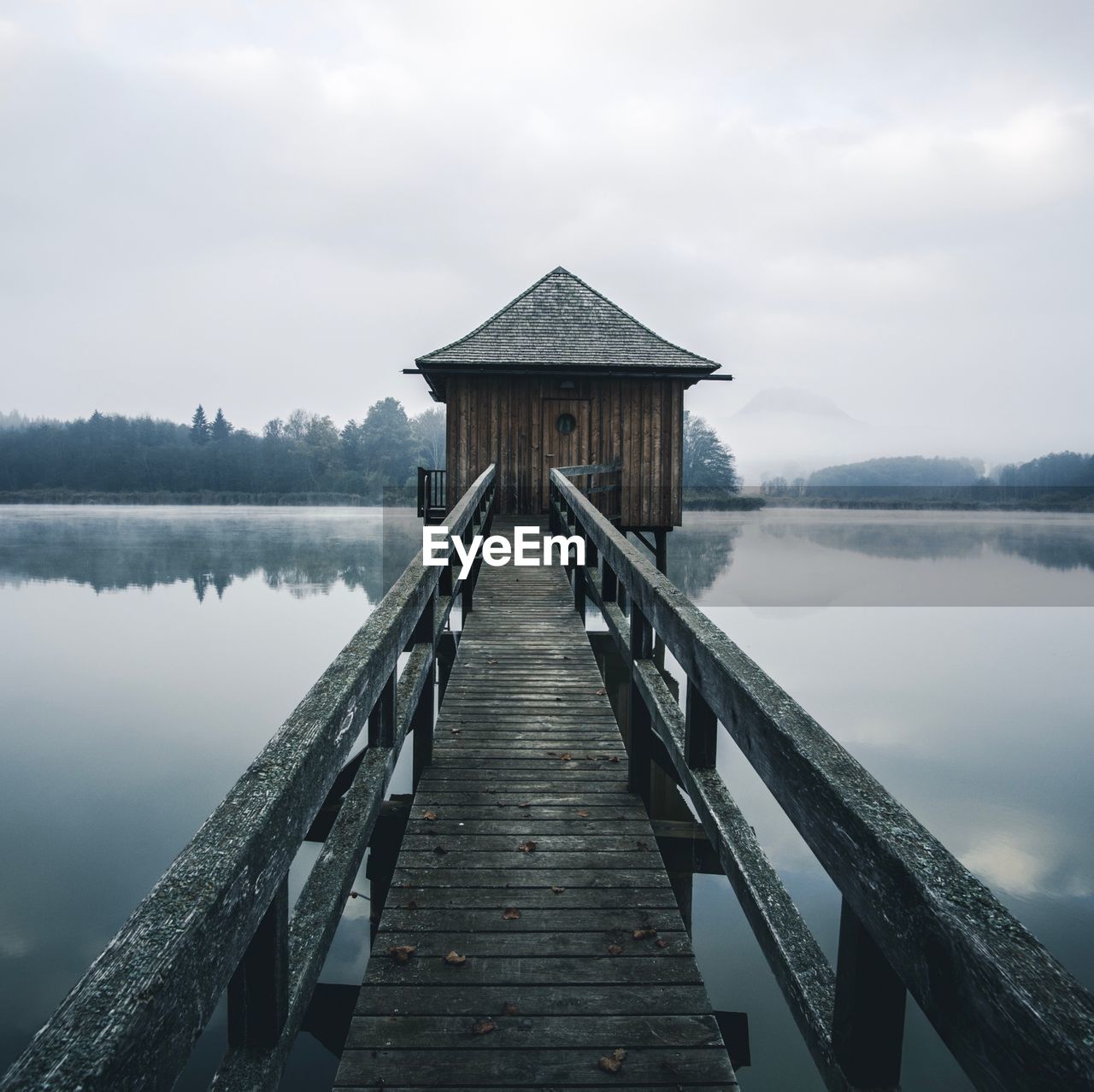 Pier over lake against sky