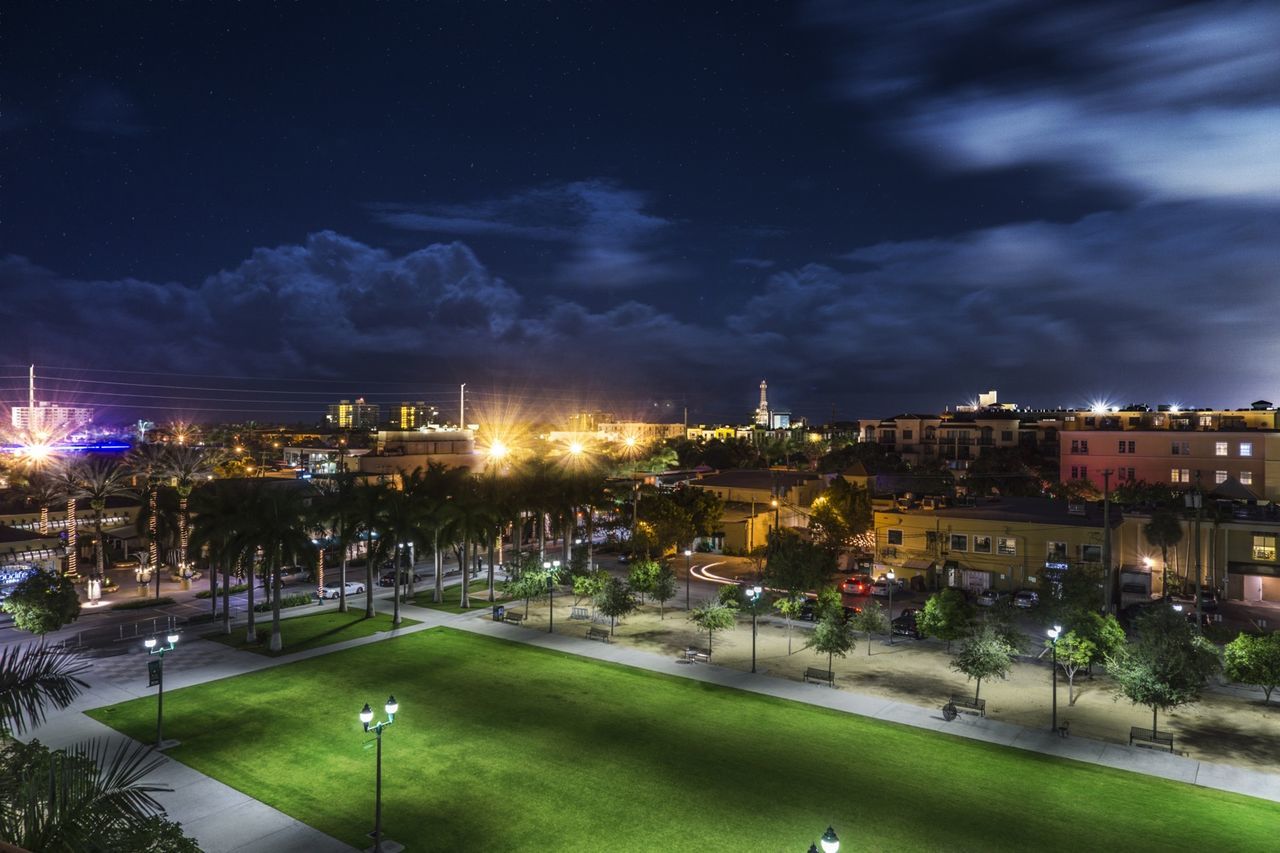 VIEW OF ILLUMINATED CITY AT NIGHT