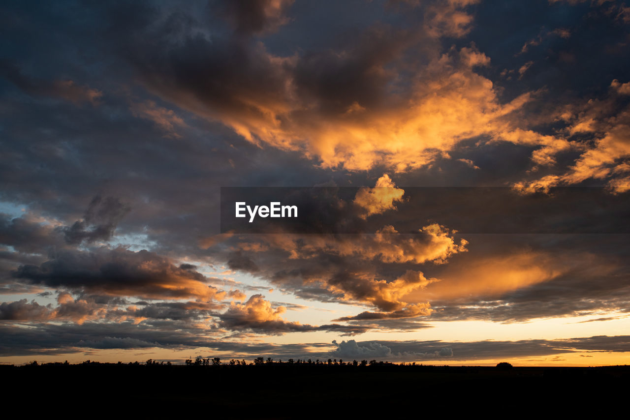SCENIC VIEW OF SILHOUETTE LANDSCAPE AGAINST DRAMATIC SKY
