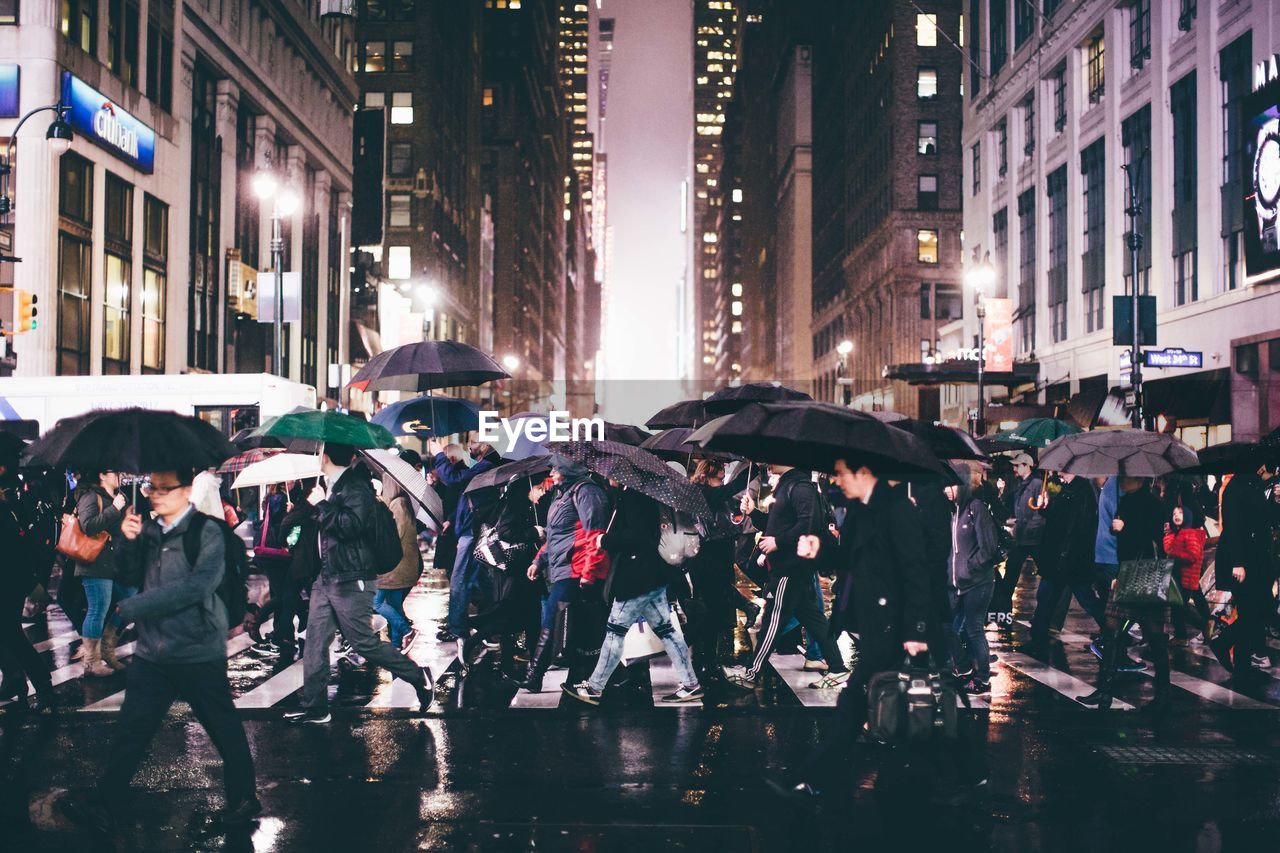 Crowd on wet street during rainy season at night