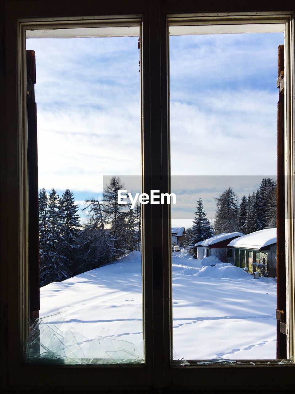 Snow covered landscape seen through window