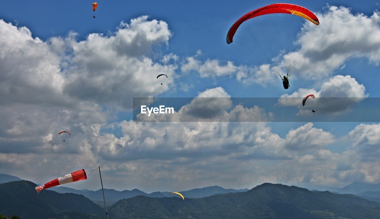 Low angle view of paragliding against sky