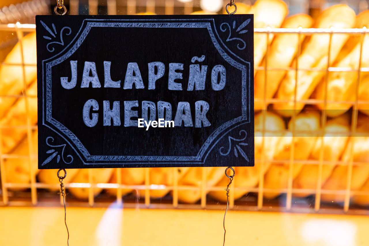 CLOSE-UP OF TEXT ON ILLUMINATED SIGN BOARD