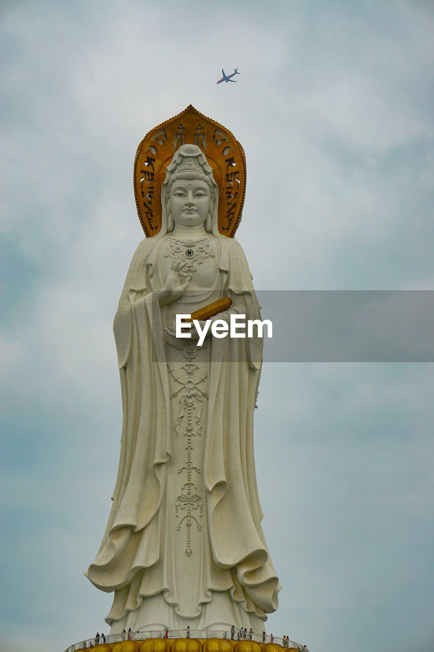 STATUE OF BUDDHA AGAINST SKY