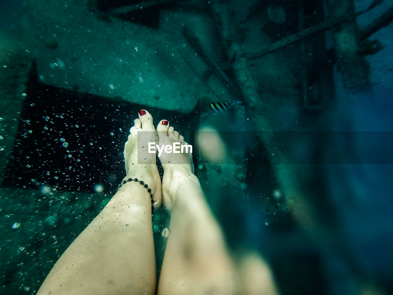 Low section of young woman in swimming pool