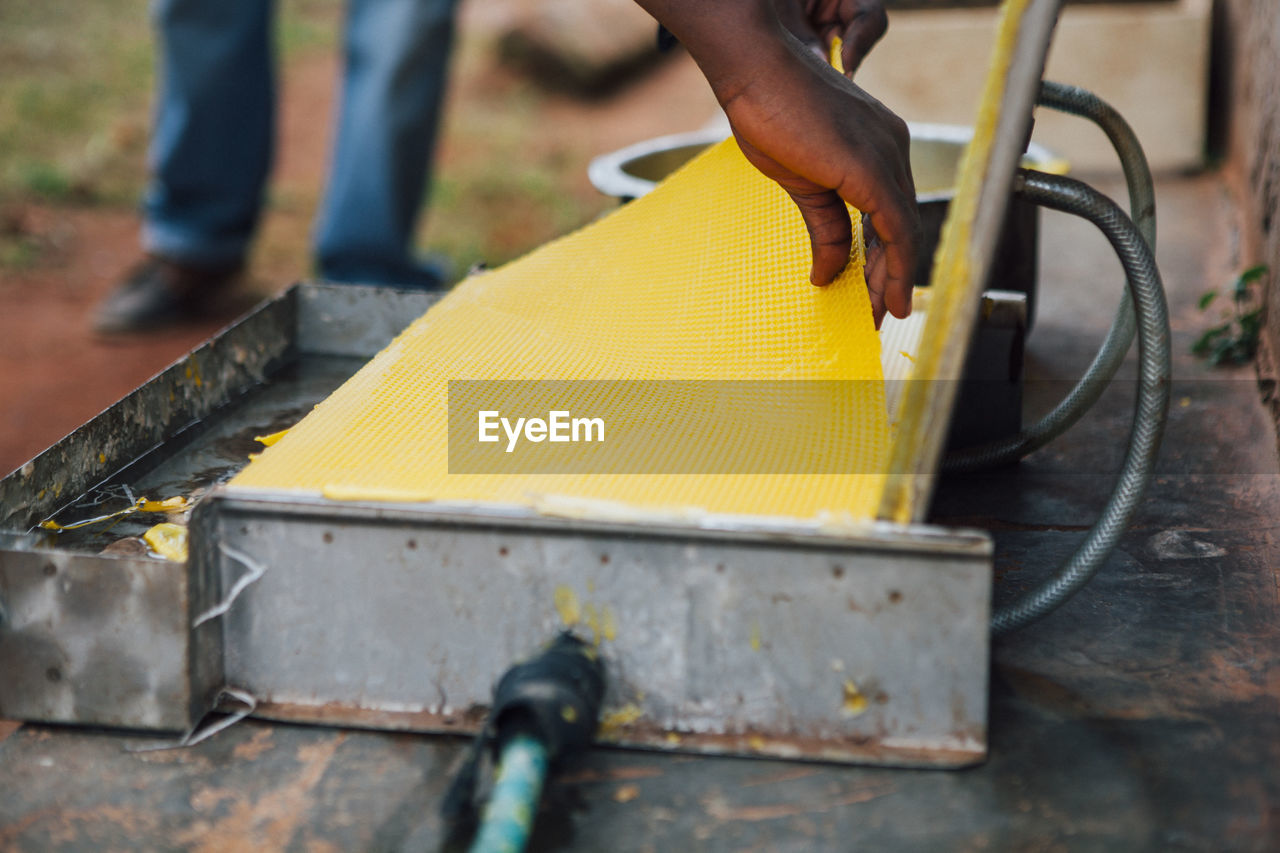 Close-up of man working on metal