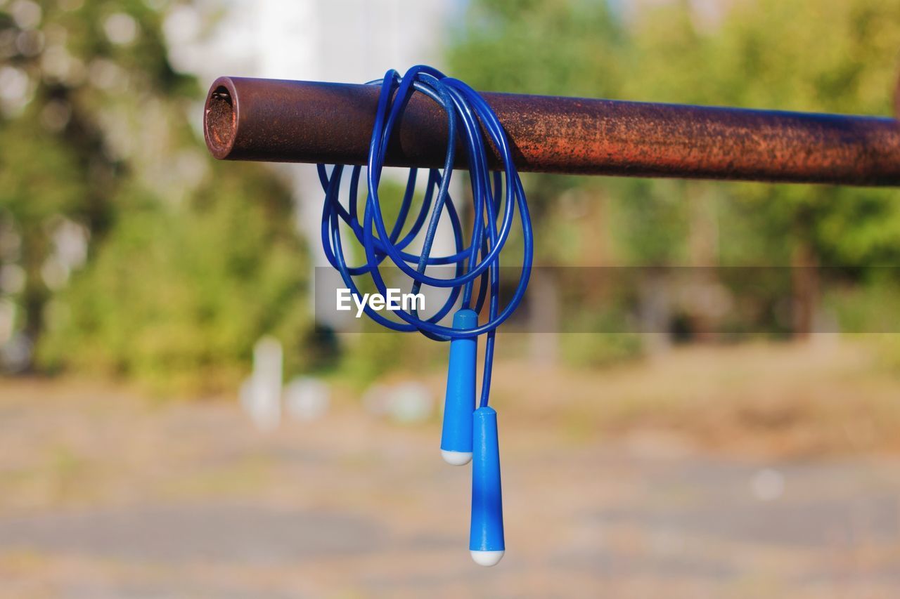 Blue jump rope hanging on the horizontal bar