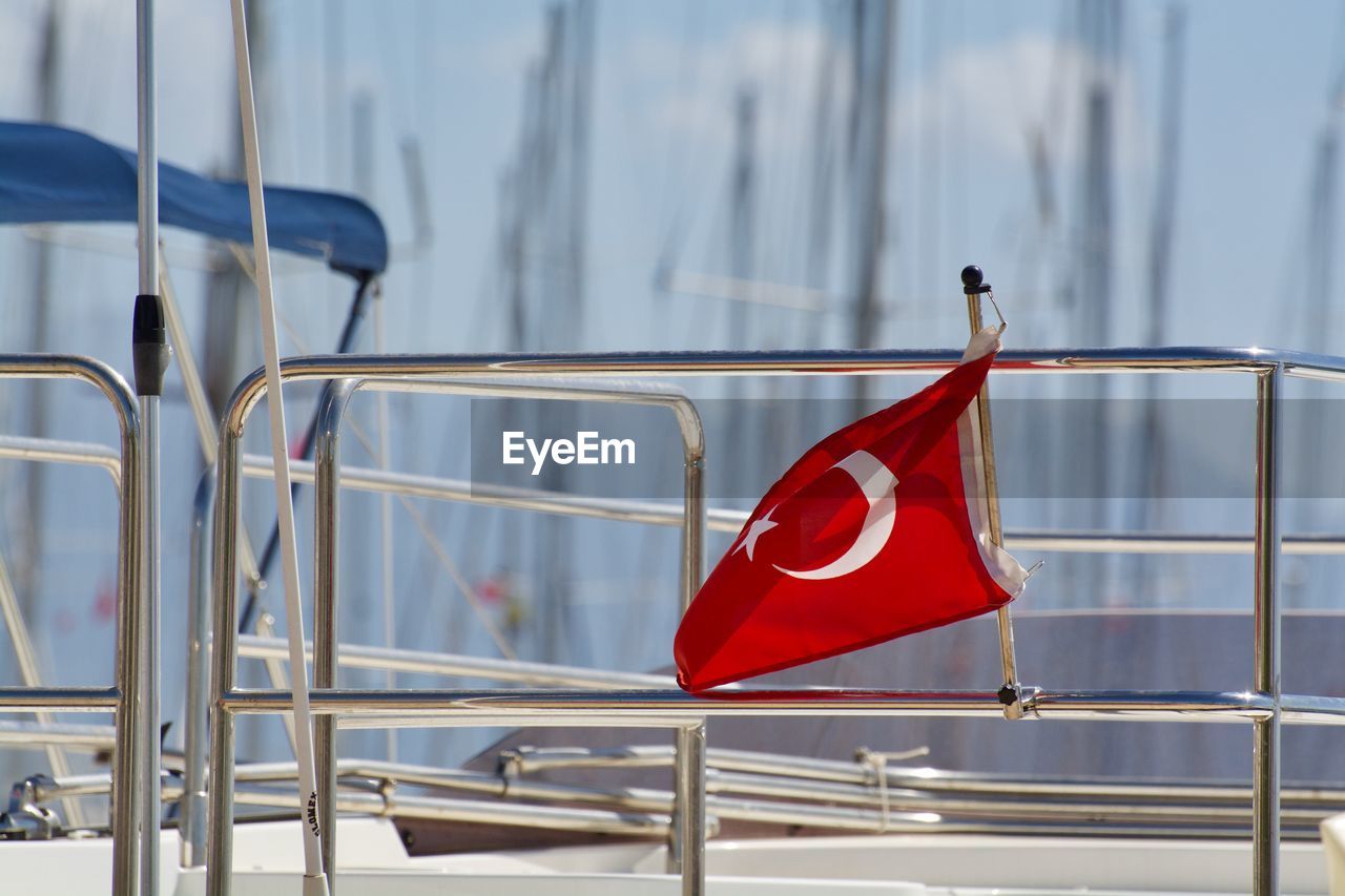 Close-up of flag on boat railing