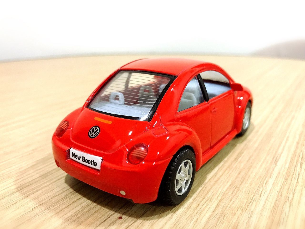 CLOSE-UP OF TOY CAR AGAINST RED SKY