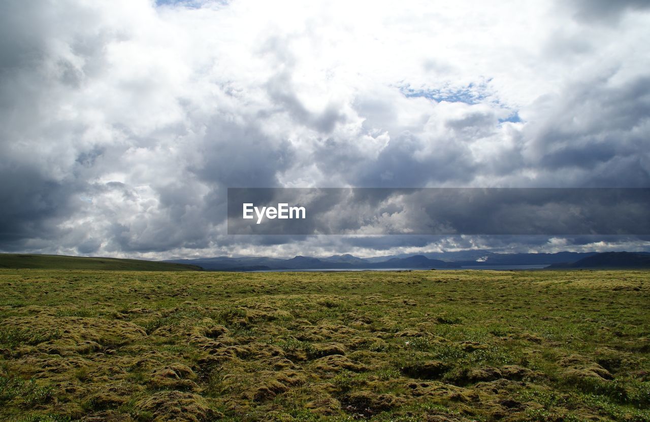 Scenic view of landscape against cloudy sky