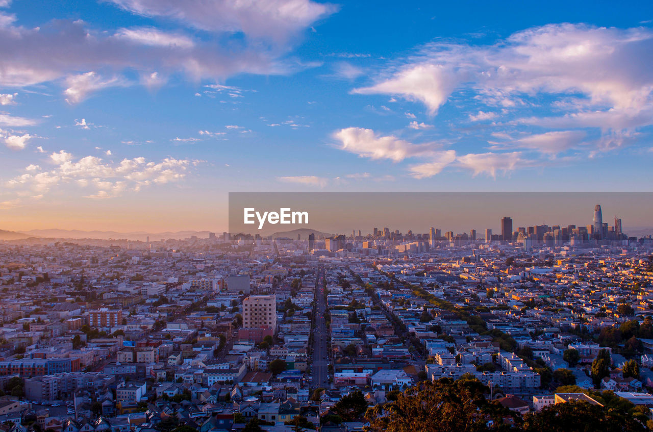 Aerial view of cityscape against sky during sunset