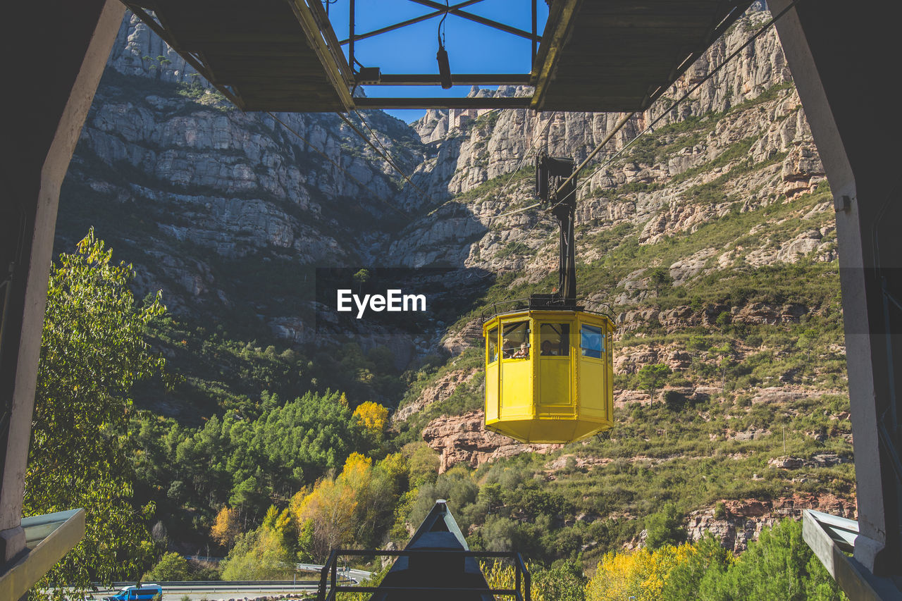 Overhead cable car against mountain