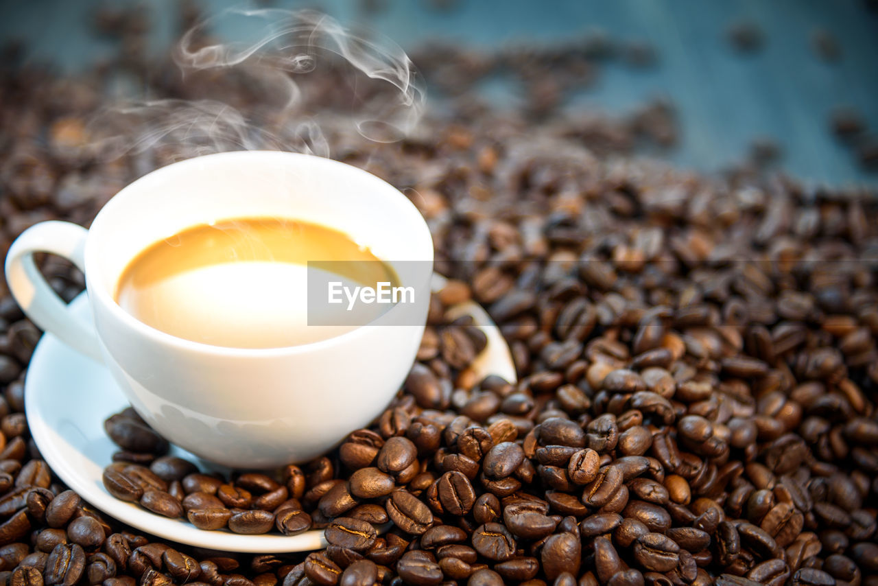 Close-up of hot coffee amidst beans