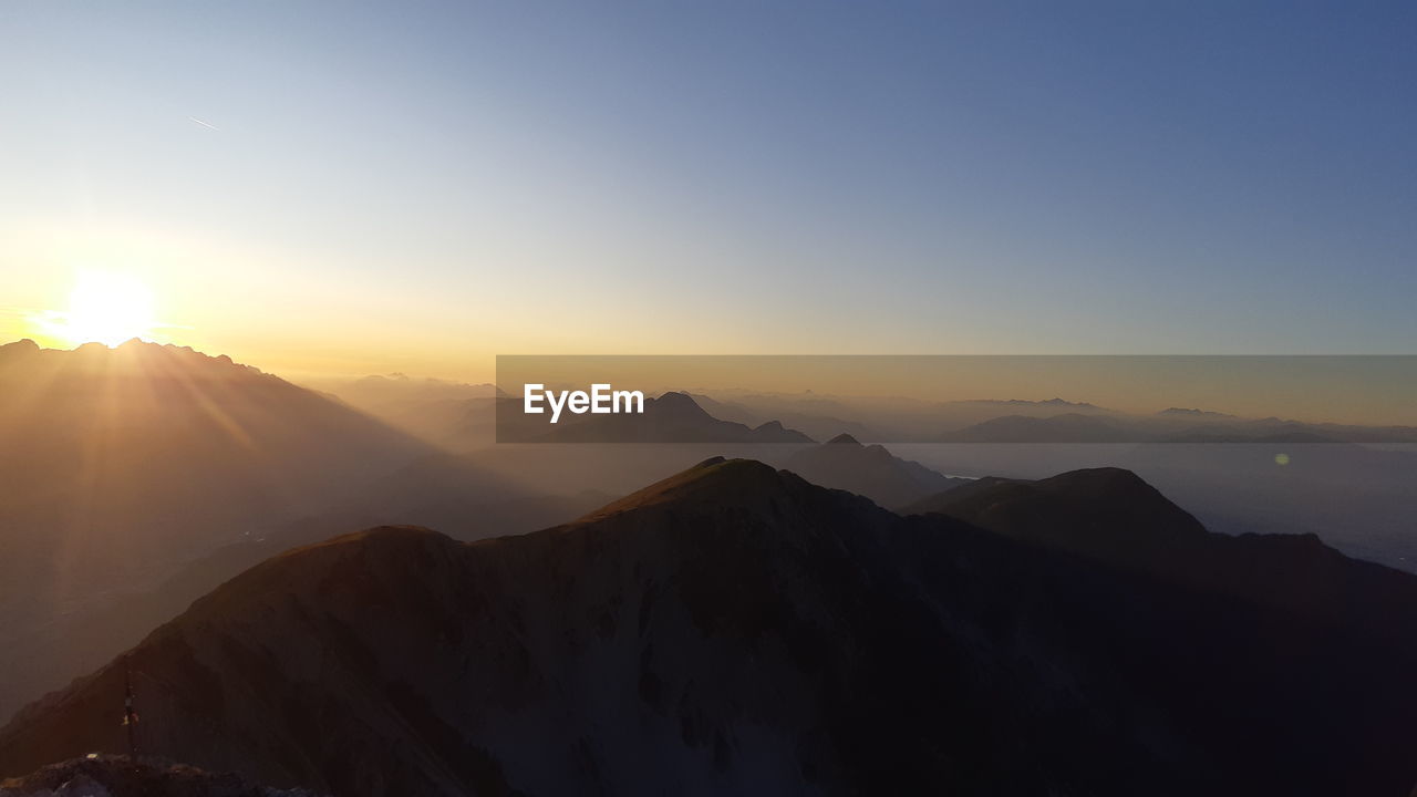 Scenic view of mountains against sky during sunset