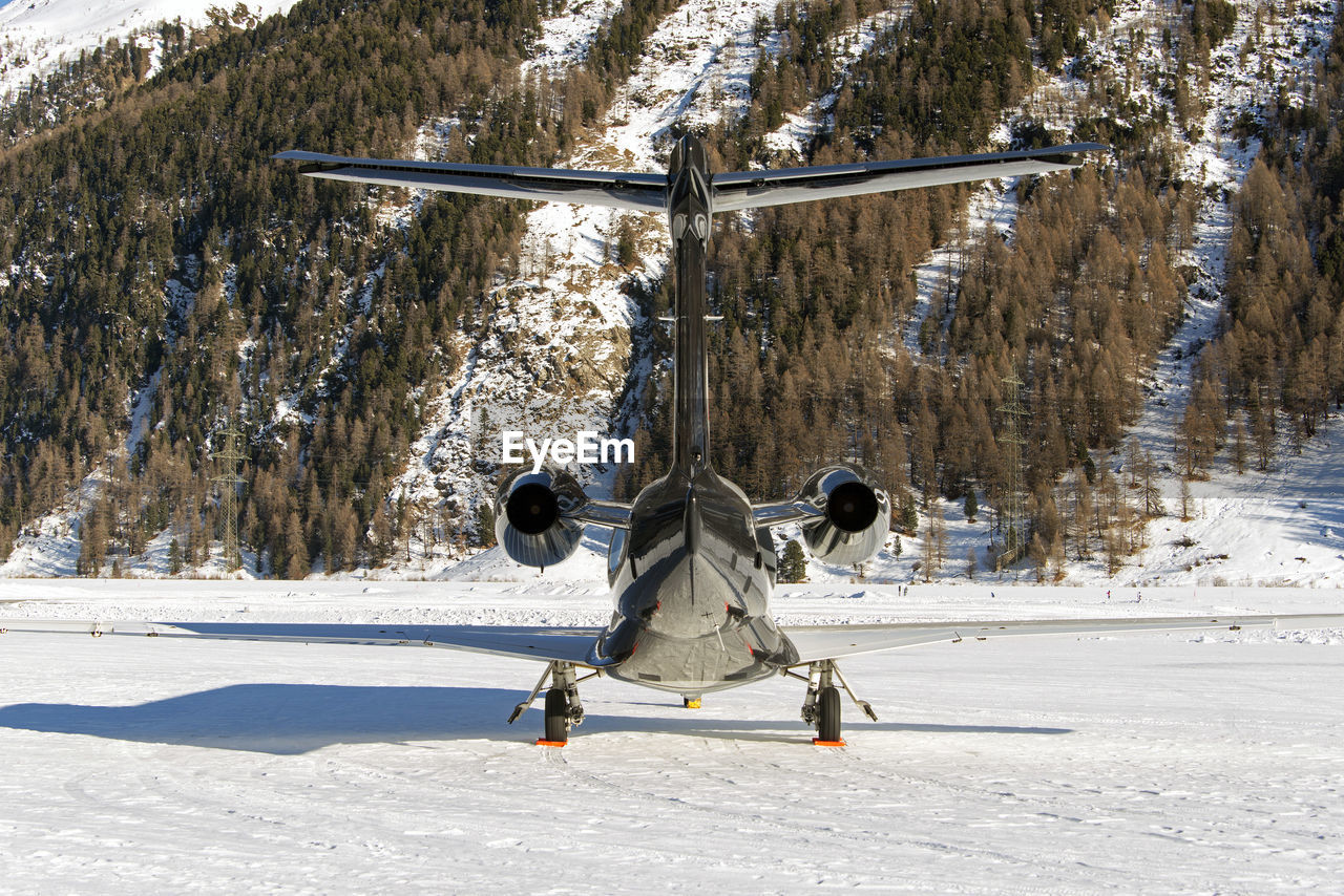 Rear view of a private jet airplane in the airport of st moritz switzerland