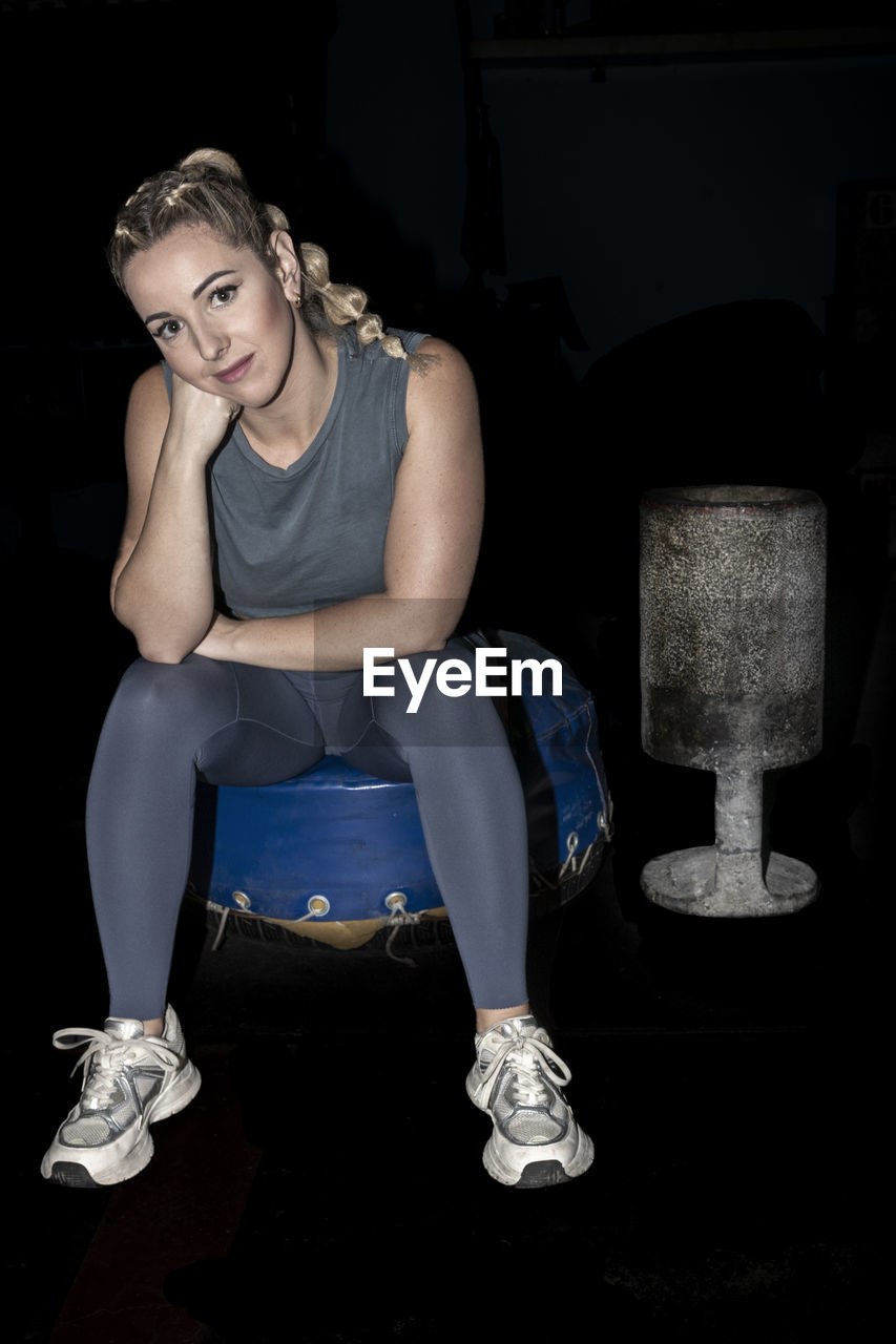 Stone lifting basque sporty woman sitting resting