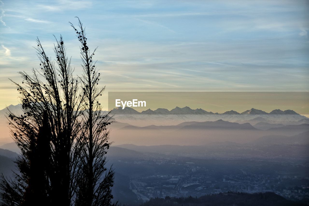 Scenic view of mountains against sky at sunset