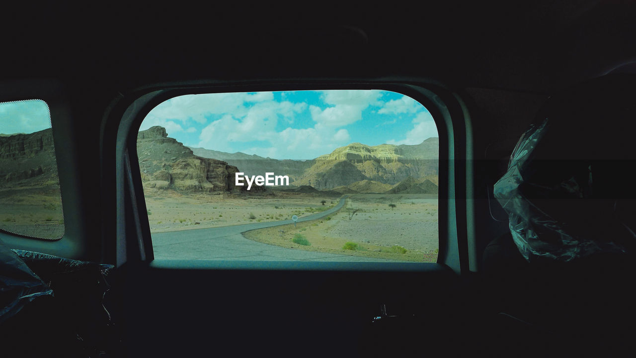 Scenic view of mountains seen through vehicle window
