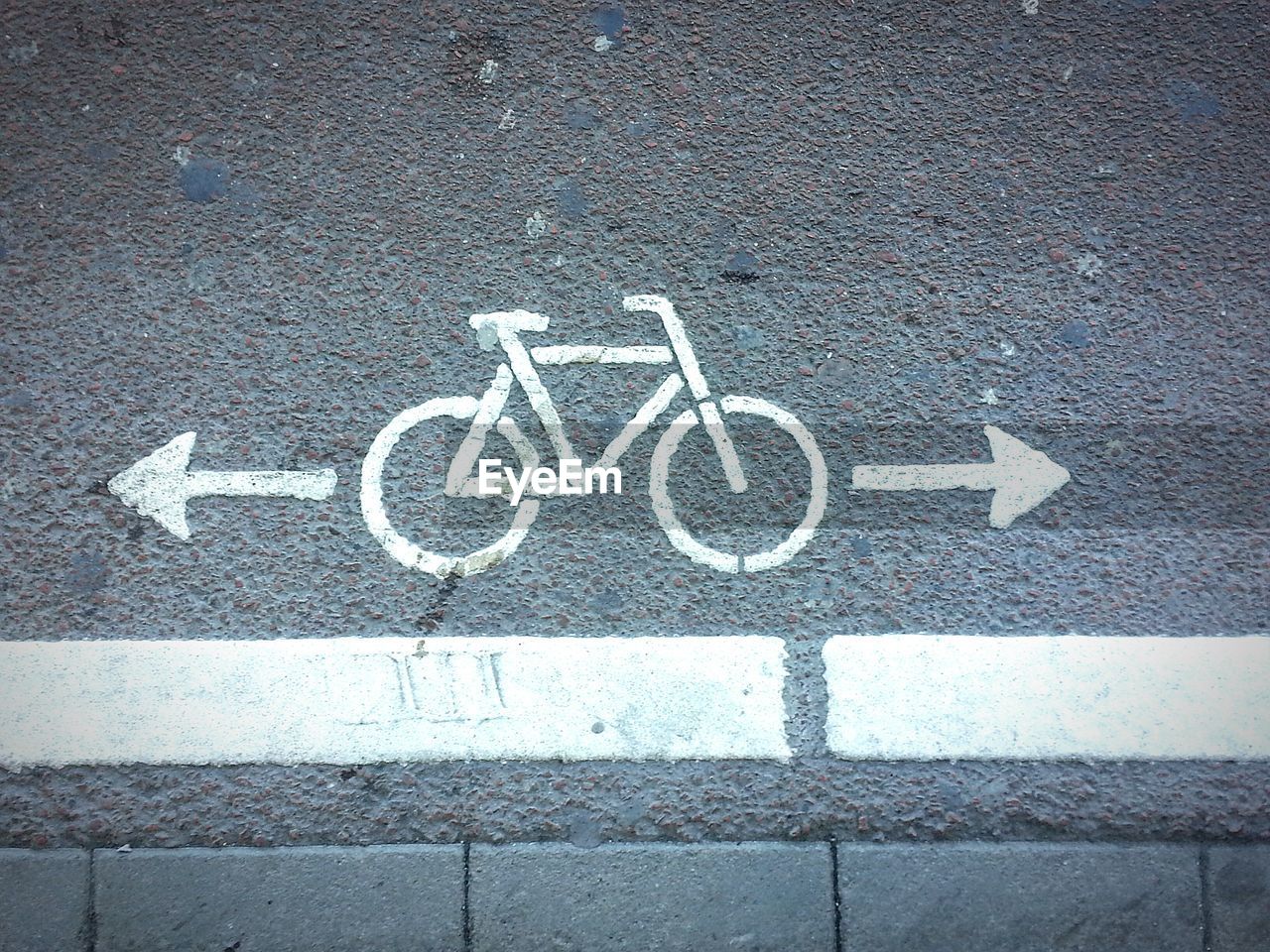 Directly above shot of bicycle lane sign on road