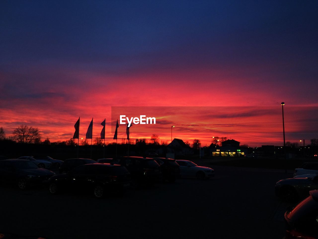 VEHICLES ON ROAD AT SUNSET