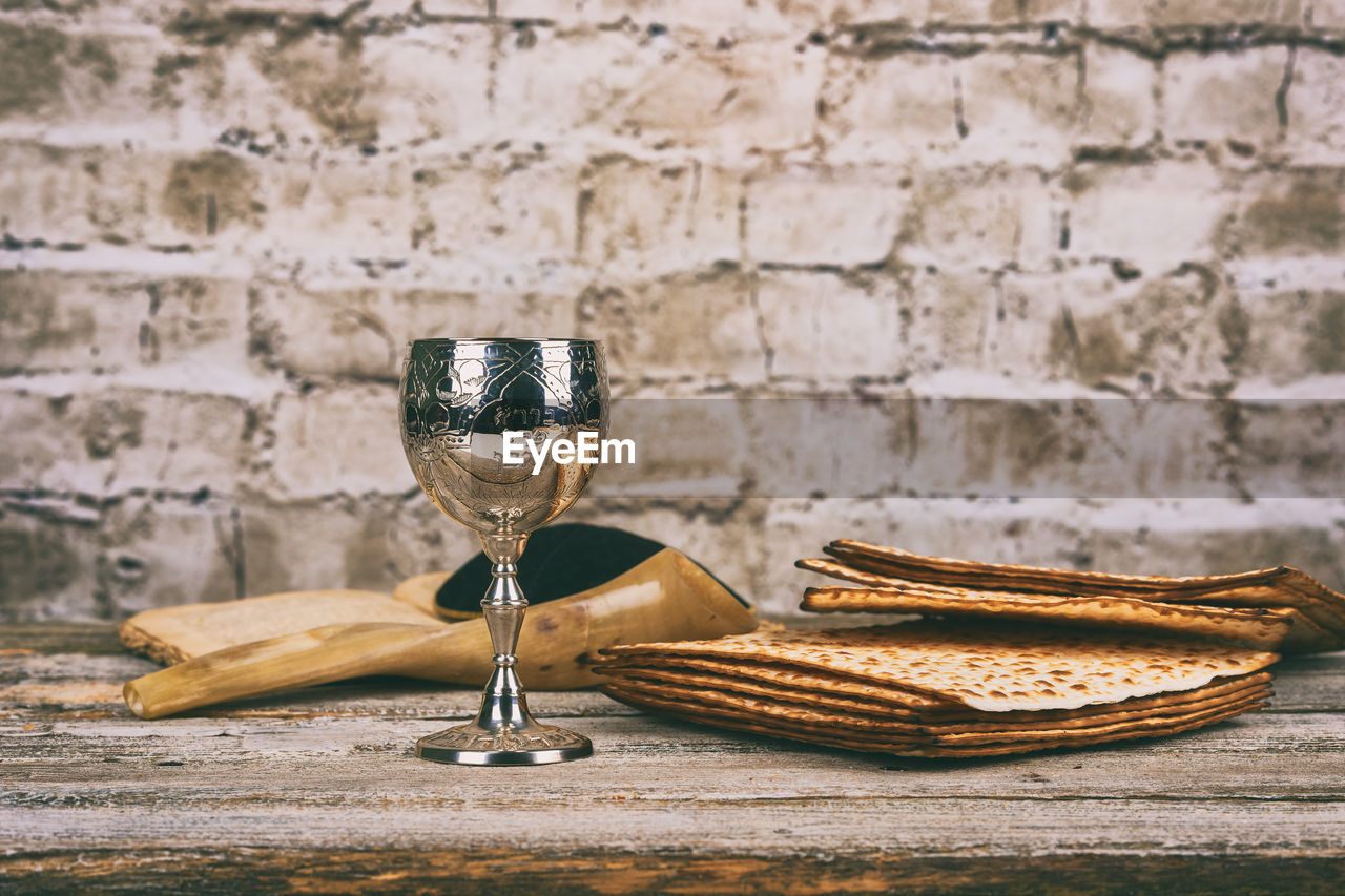 High angle view of wine with crackers and book on wooden table