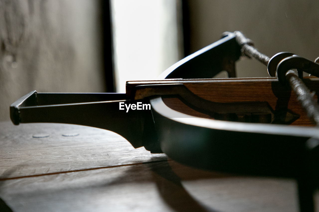 Close-up of cross bow on table