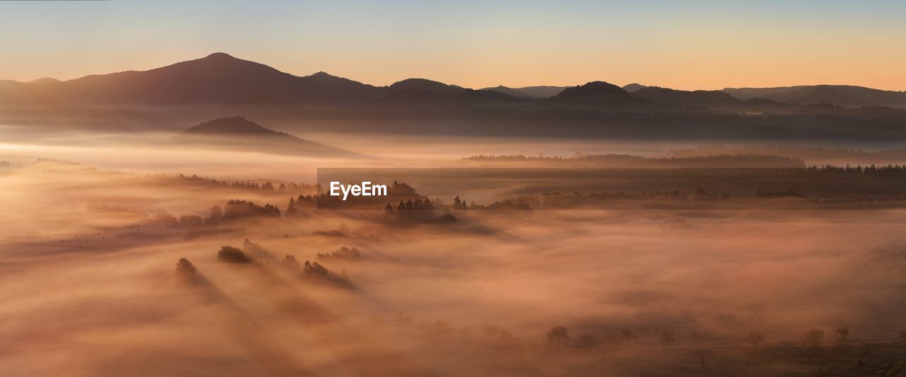 SCENIC VIEW OF MOUNTAINS DURING SUNSET