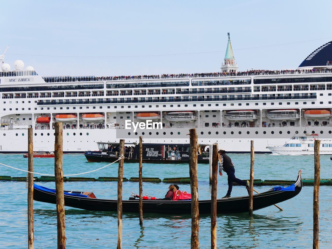 PEOPLE IN BOAT IN CITY