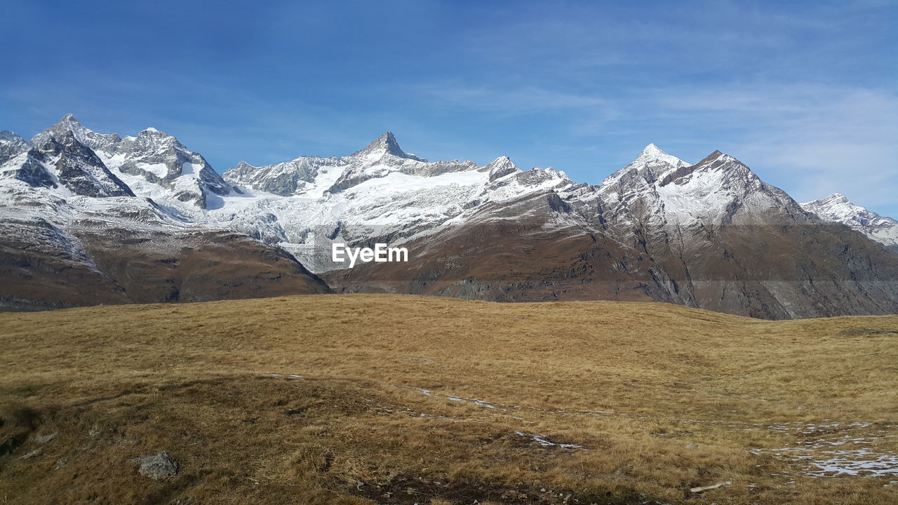 Scenic view of snowcapped mountains against sky