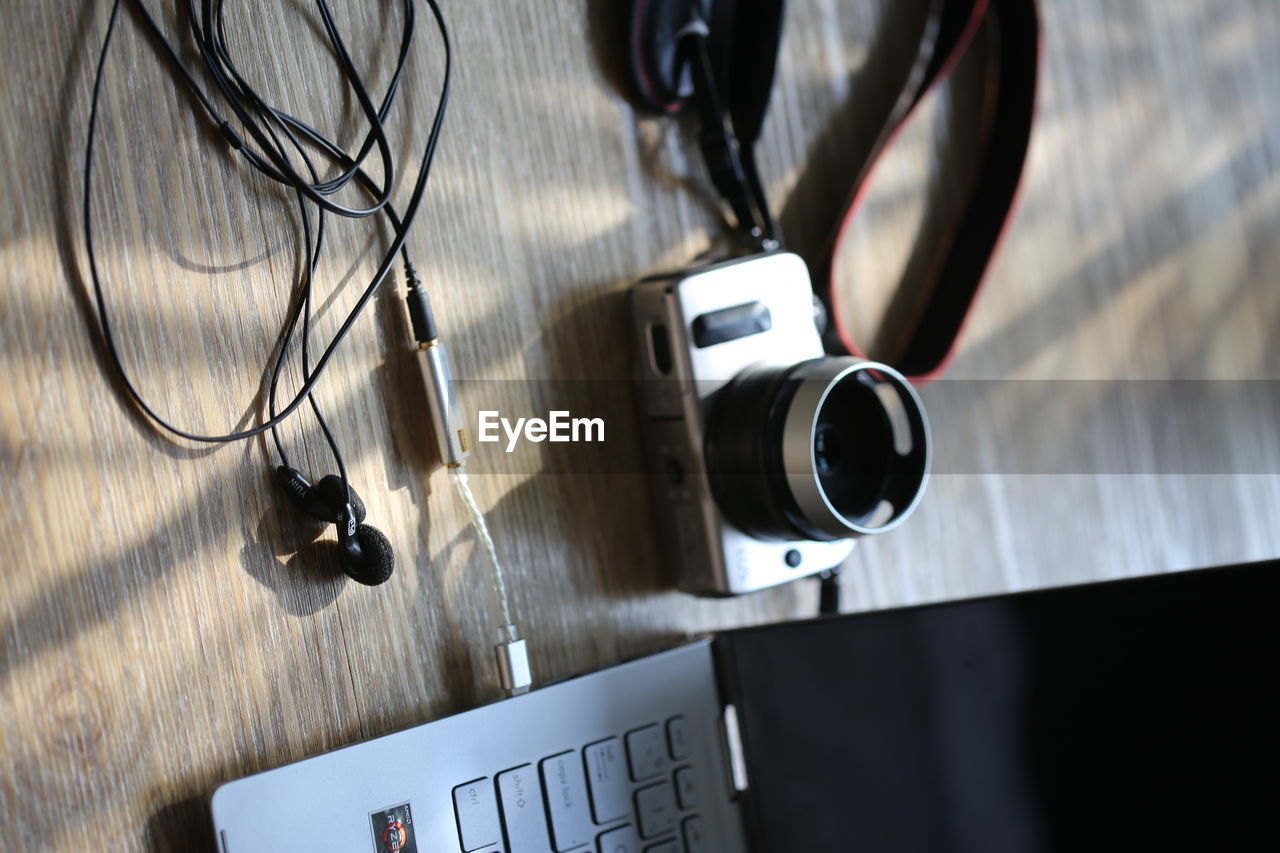 high angle view of camera and headphones on table