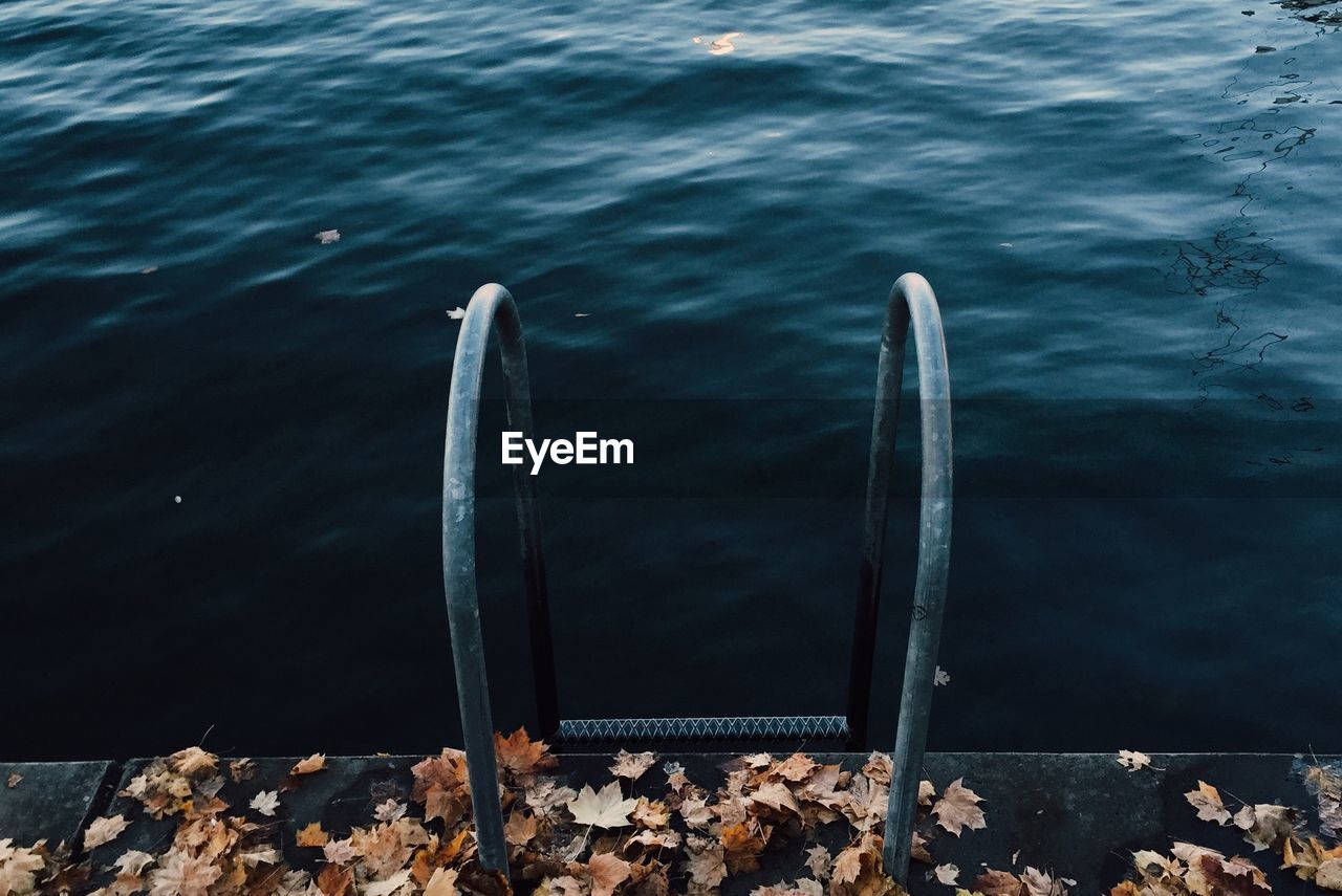 High angle view of railing on pier over lake